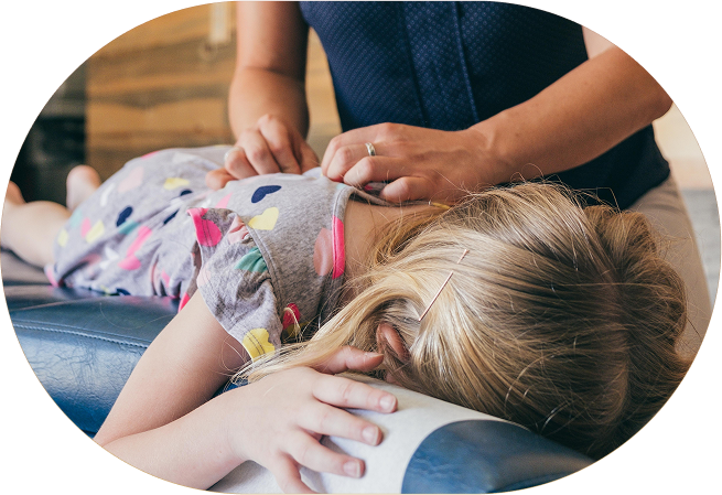 young girl laying face down receiving pediatric chiropractic care