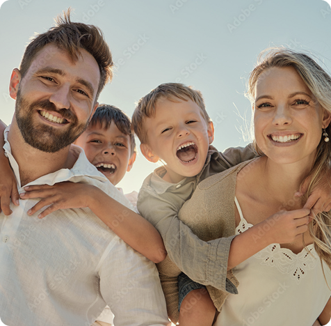 family with mother and father and two little boys riding on their backs