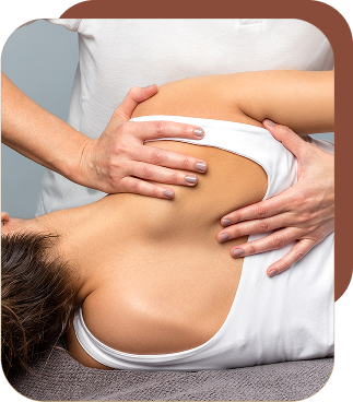a chiropractor working on a patient's shoulder